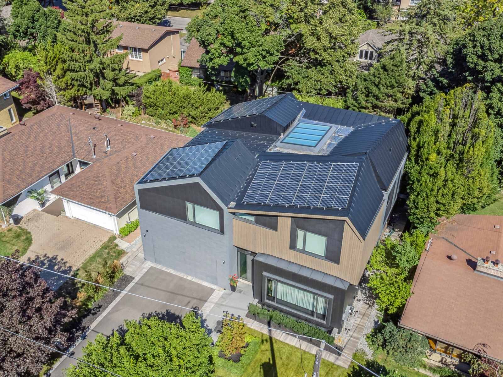 custom home exterior room with sky light and solar panels