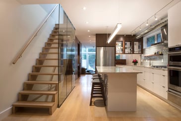 custom kitchen renovation in toronto with floating staircase and glass siding