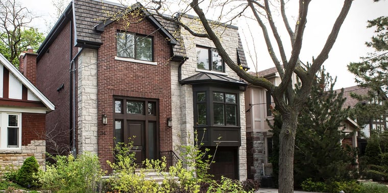Custom house exterior with mahogany front door and clay brick