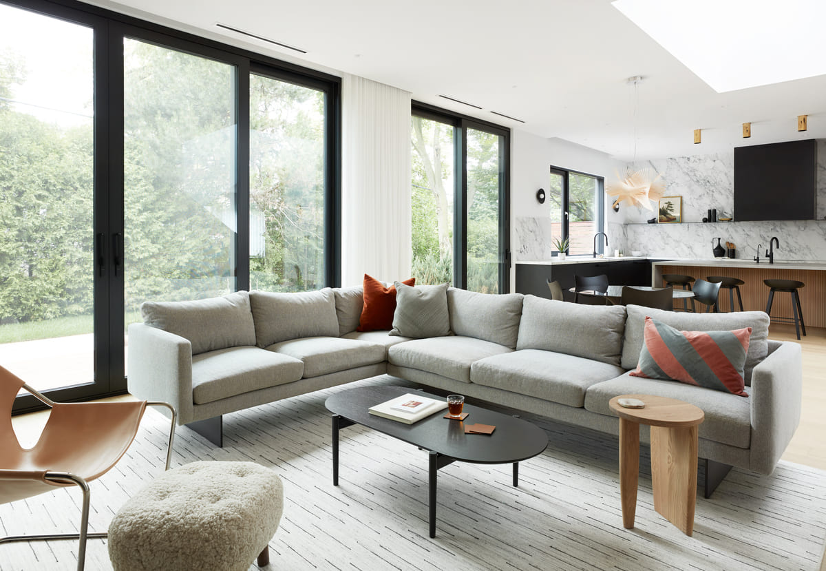 Floor-to-ceiling windows with black framing in living area