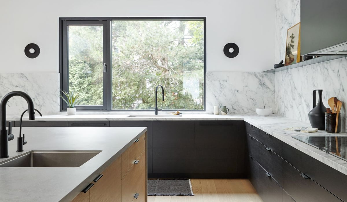 Japandi style kitchen with marble slab backsplash and window