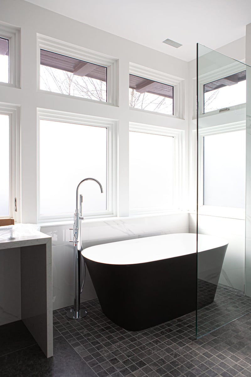 Luxury custom bathroom with tub shower combo by windows