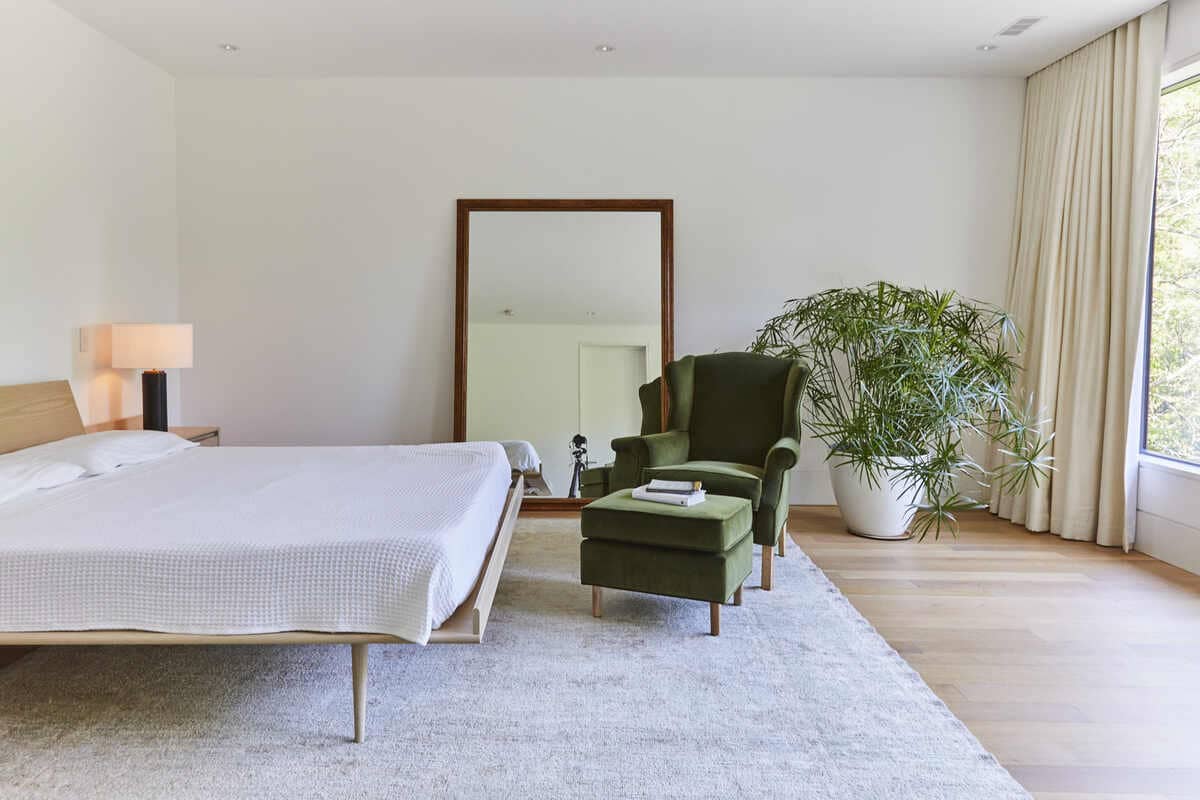 Minimalist bedroom with wood flooring and natural light