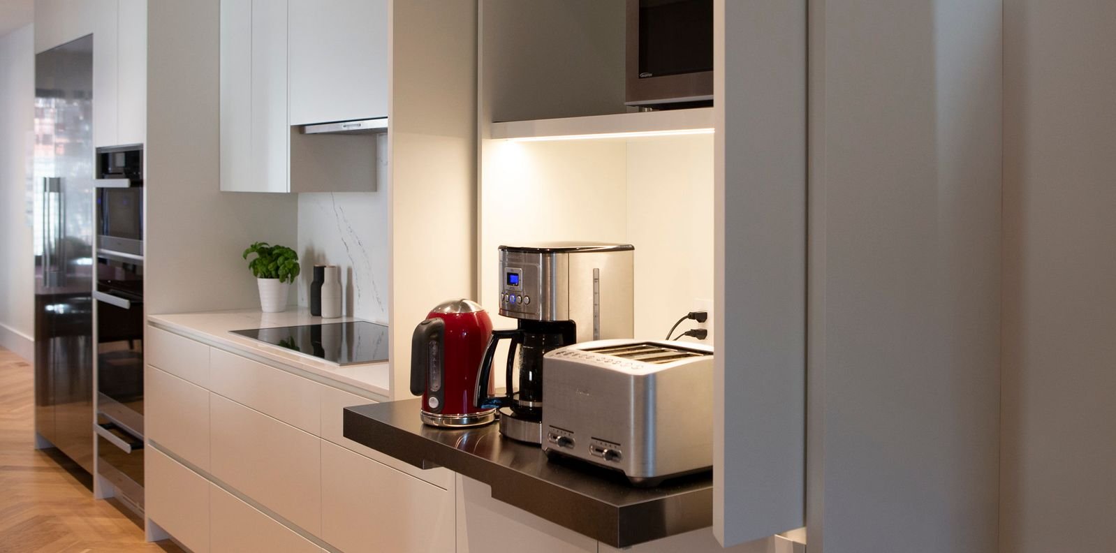 modern built in cabinetry with pull out shelf and appliances in toronto