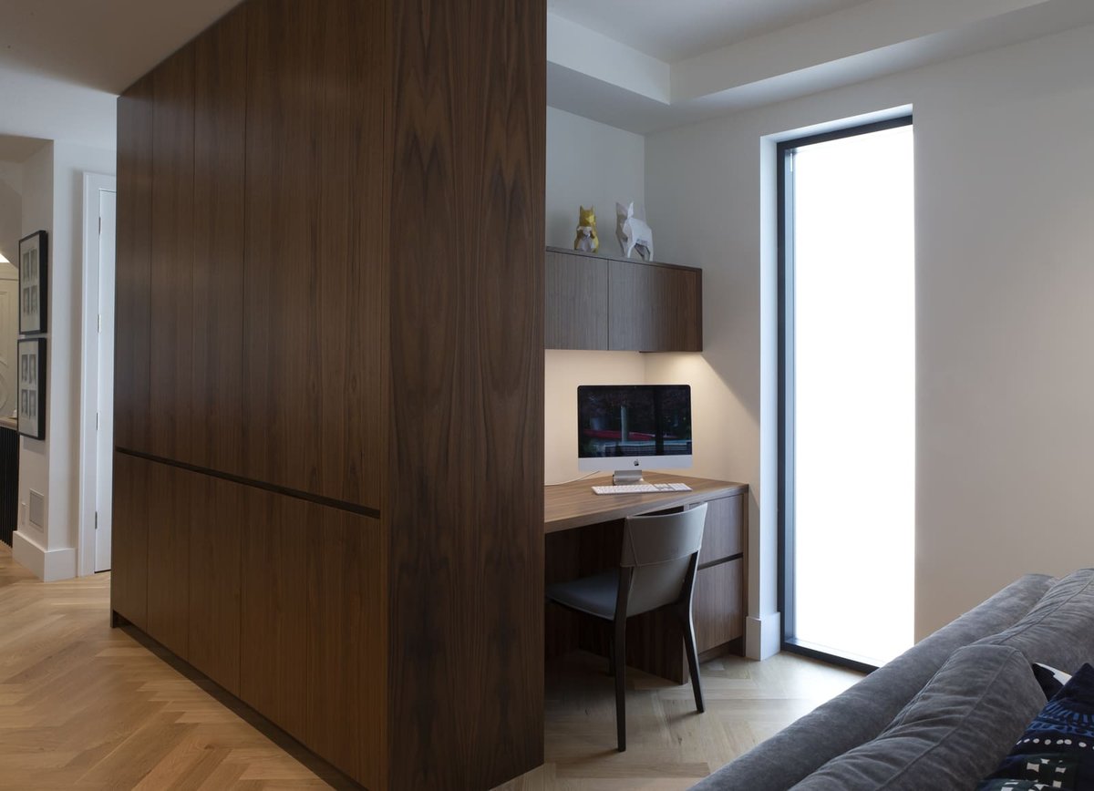 Modern custom home office design behind floor-to-ceiling cabinetry