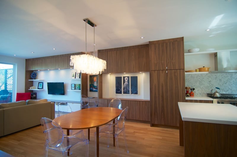 Open-concept custom home view of dining area in between kitchen and living room