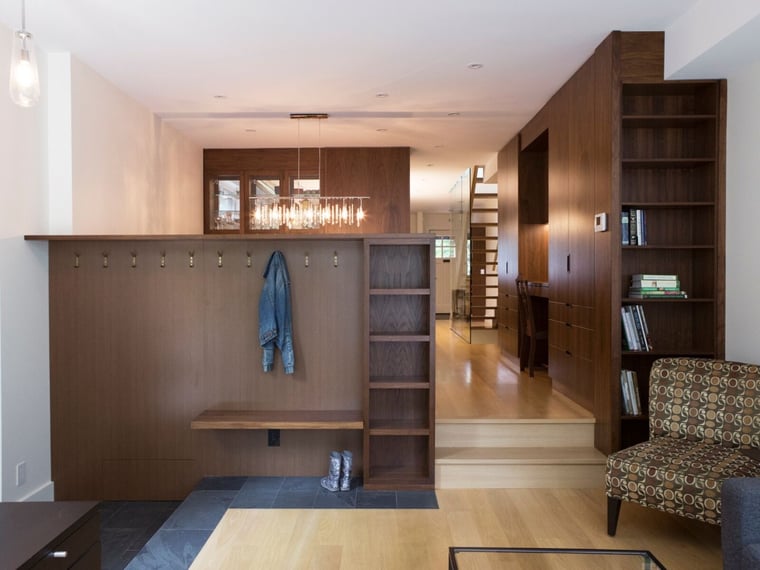 sleek modern mudroom with bespoke millwork and coat rack