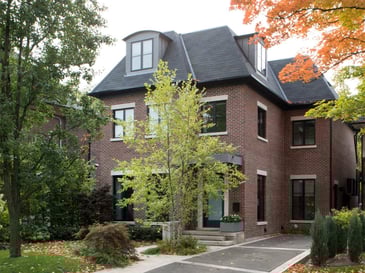 exterior view of brick home addition in Toronto with mature landscaping and trees