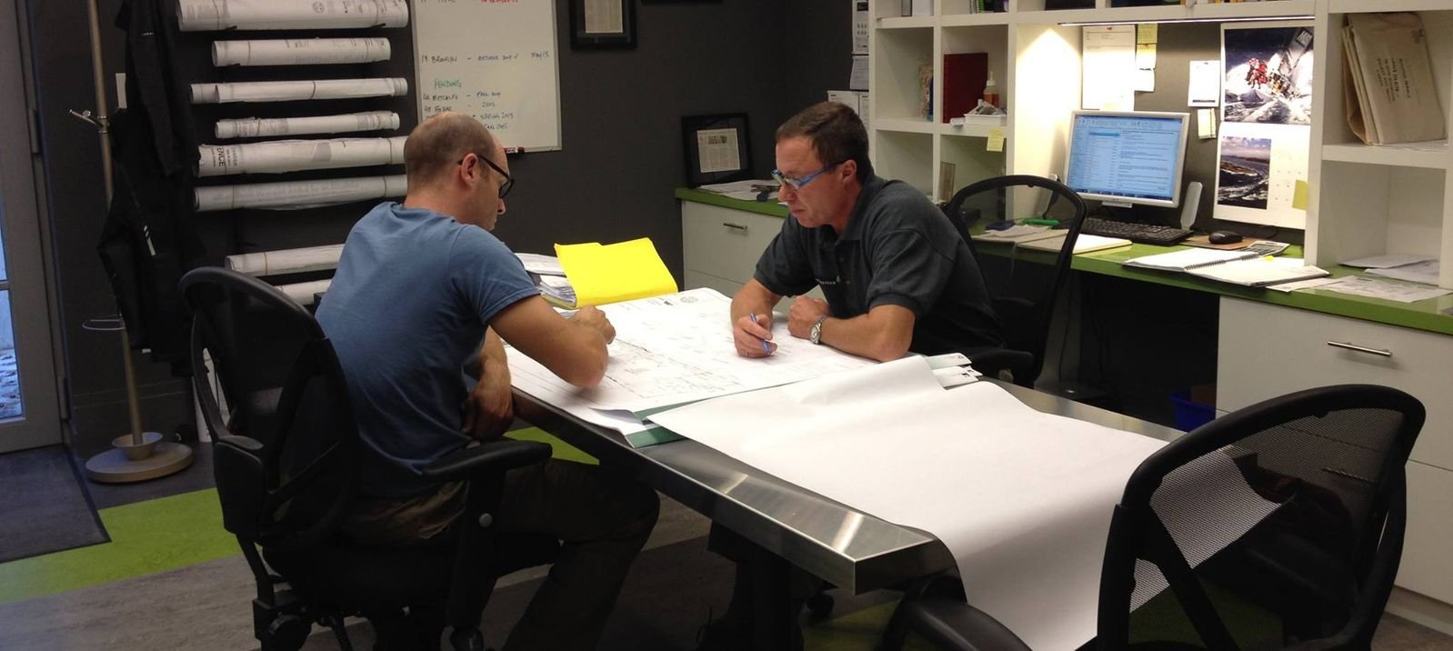tom cumming and architect working together on blueprint for custom home