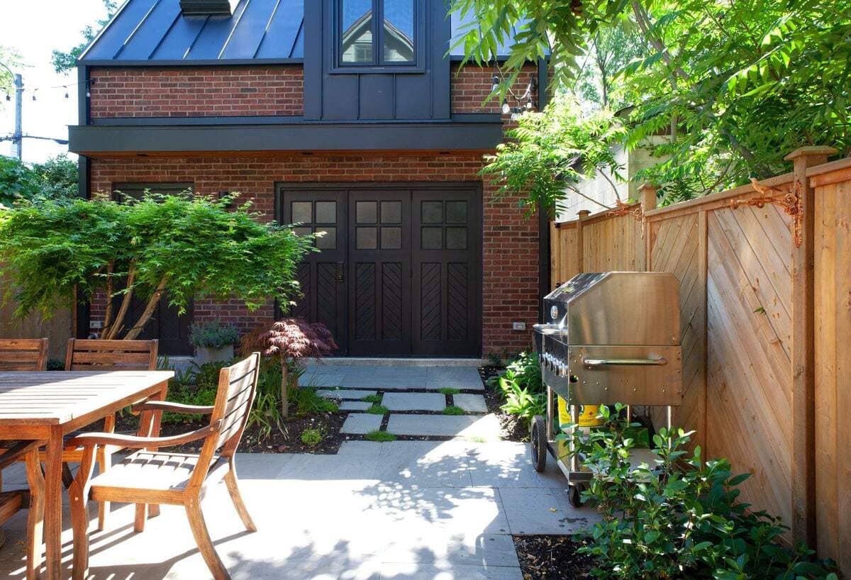 Backyard Exterior of Traditional Brick Laneway Home With Outdoor Seating Area and Grill