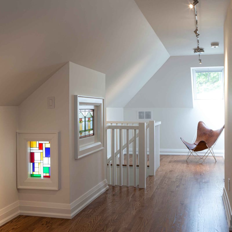 Two stained glass windows in custom home with sloped roof