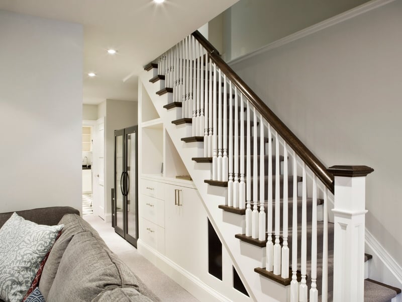 white staircase with cupboards built in underneath stairs
