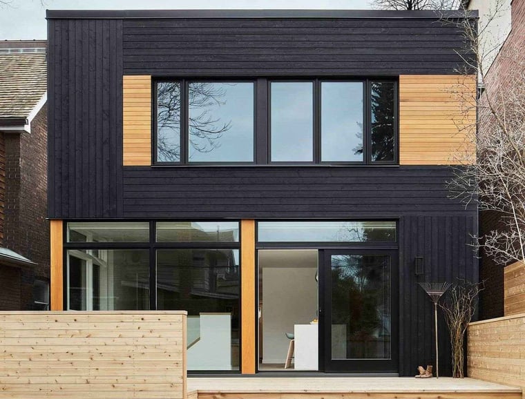 Whole home renovation exterior with cedar cladding and floor-to-ceiling windows