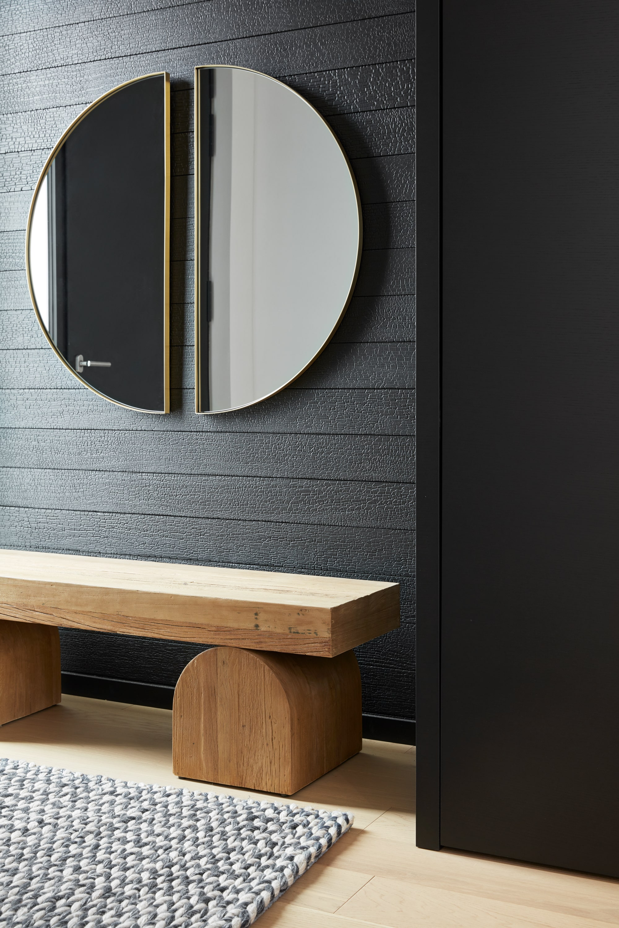 yakisugi (shou sagi ban) in entry way of modern home with circular wooden bench