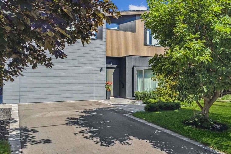 Zinc modern cladding roof on architecturally designed custom home with trees in view