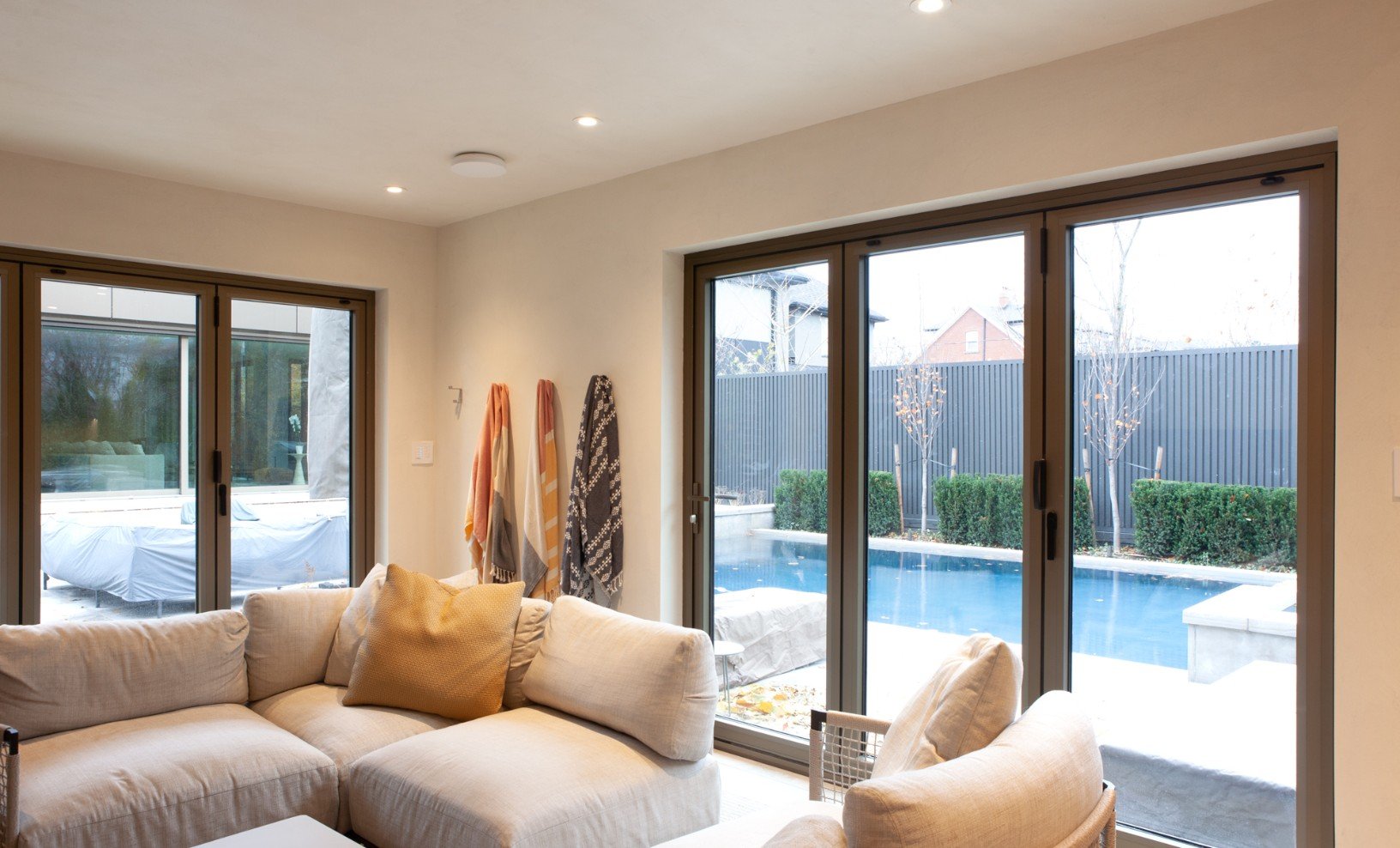 toronto-addition-interior-with-glass-front-doors-to-backyard-pool-by-severnwoods