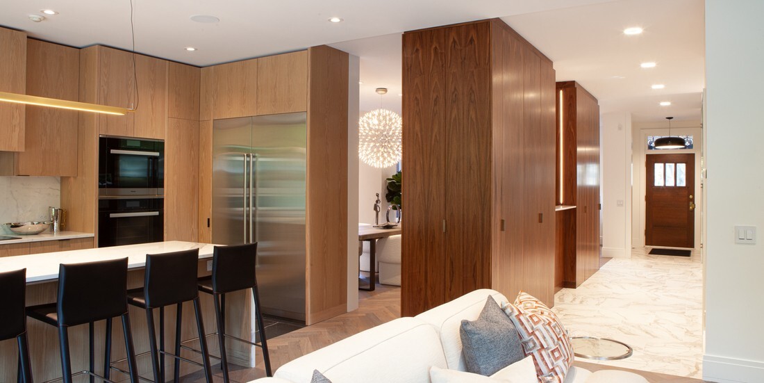 custom-home-interior-with-view-of-kitchen-and-front-door-in-open-concept-layout