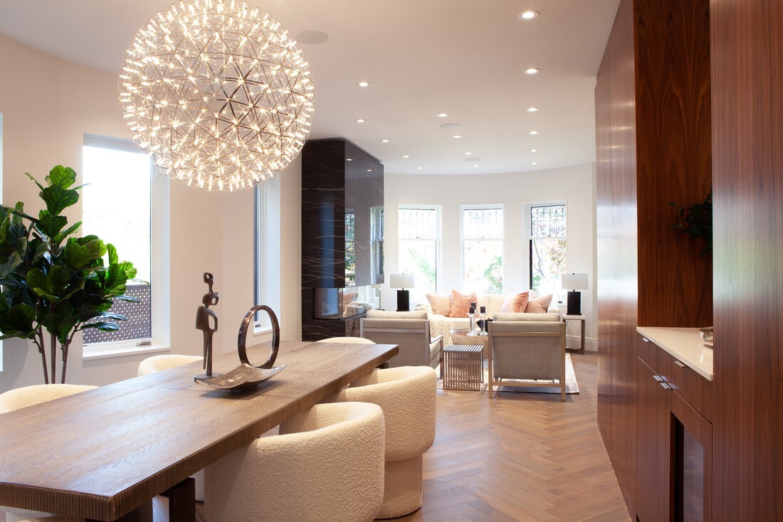 dining-room-and-view-of-living-room-with-hanging-spherical-chandelier-above-table-in-rosedale,-toronto-custom-home