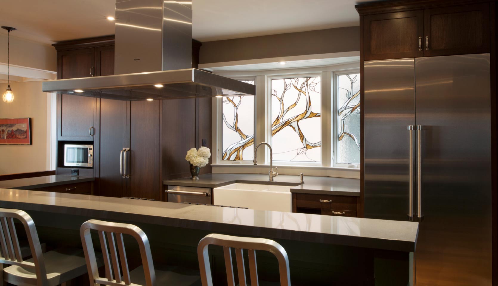 Modern country kitchen renovation with recessed panel cabinets and island with farmhouse sink