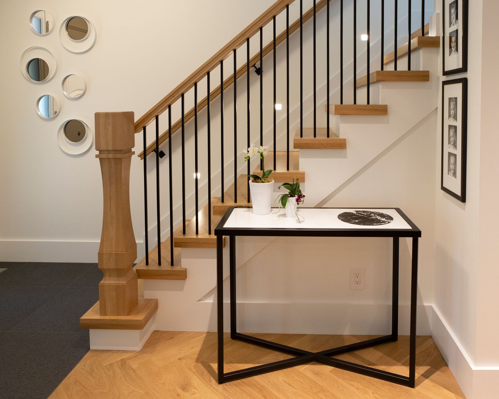 Custom home foyer with modern wooden staircase