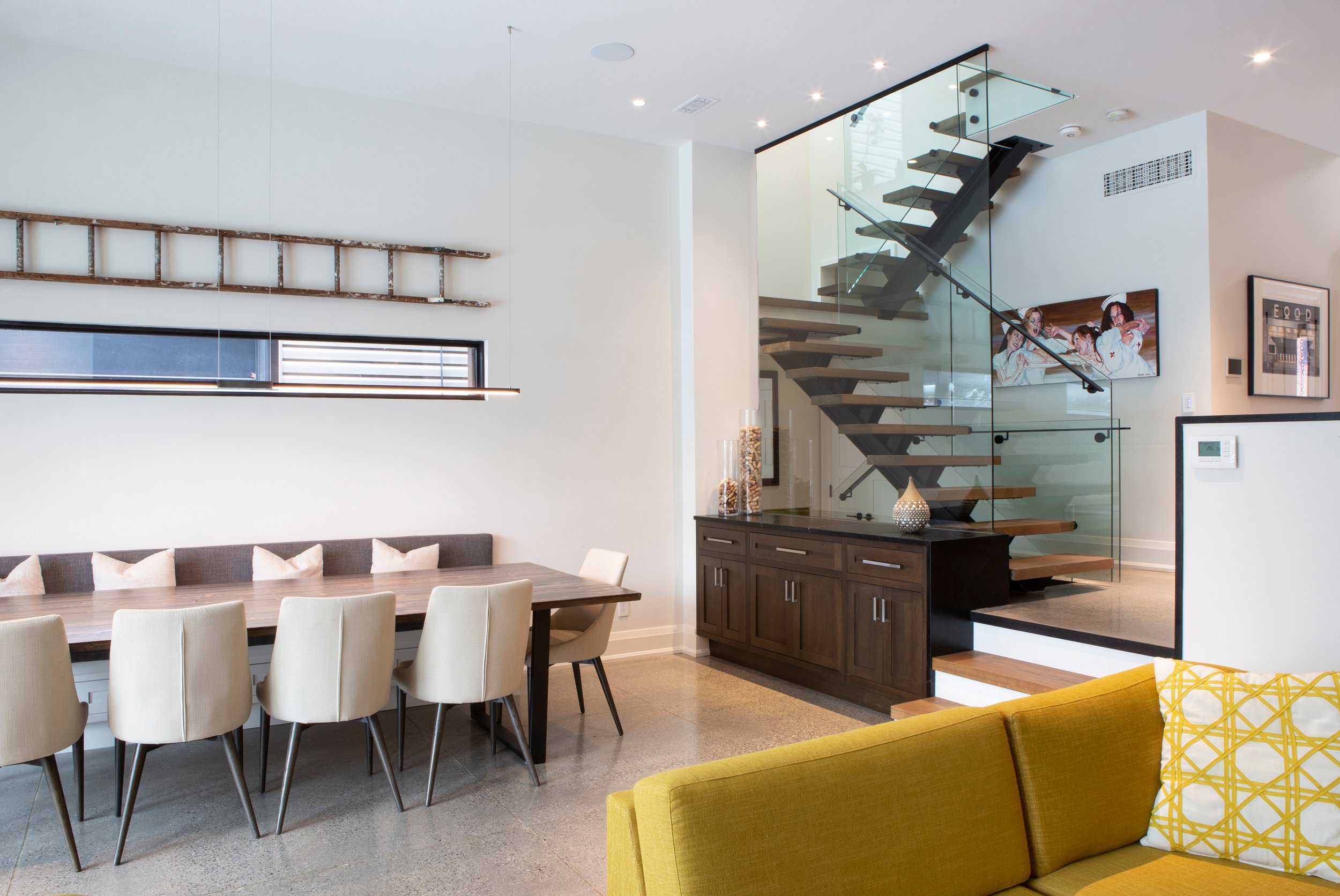 Leslieville Century Home Renovation with dining area and glass staircase