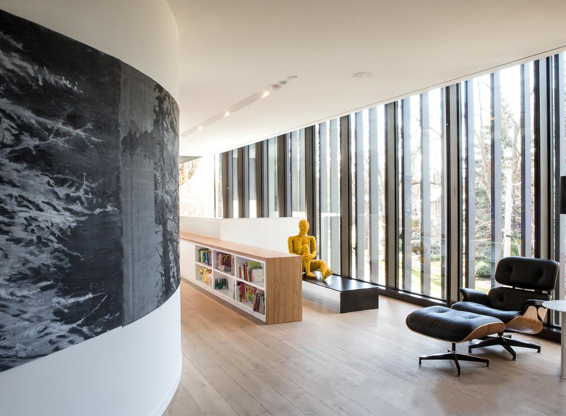 Toronto luxury custom home with curved wall with picture windows and Eames Lounge Chair and Ottoman