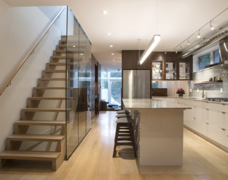 modern home renovation of kitchen, island, and floating staircase in toronto