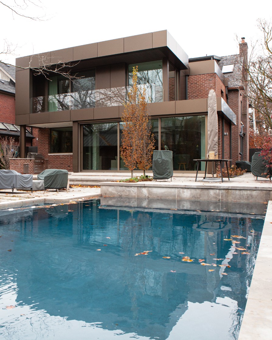 Backyard shot of addition and renovation in Toronto with pool by SevernWoods