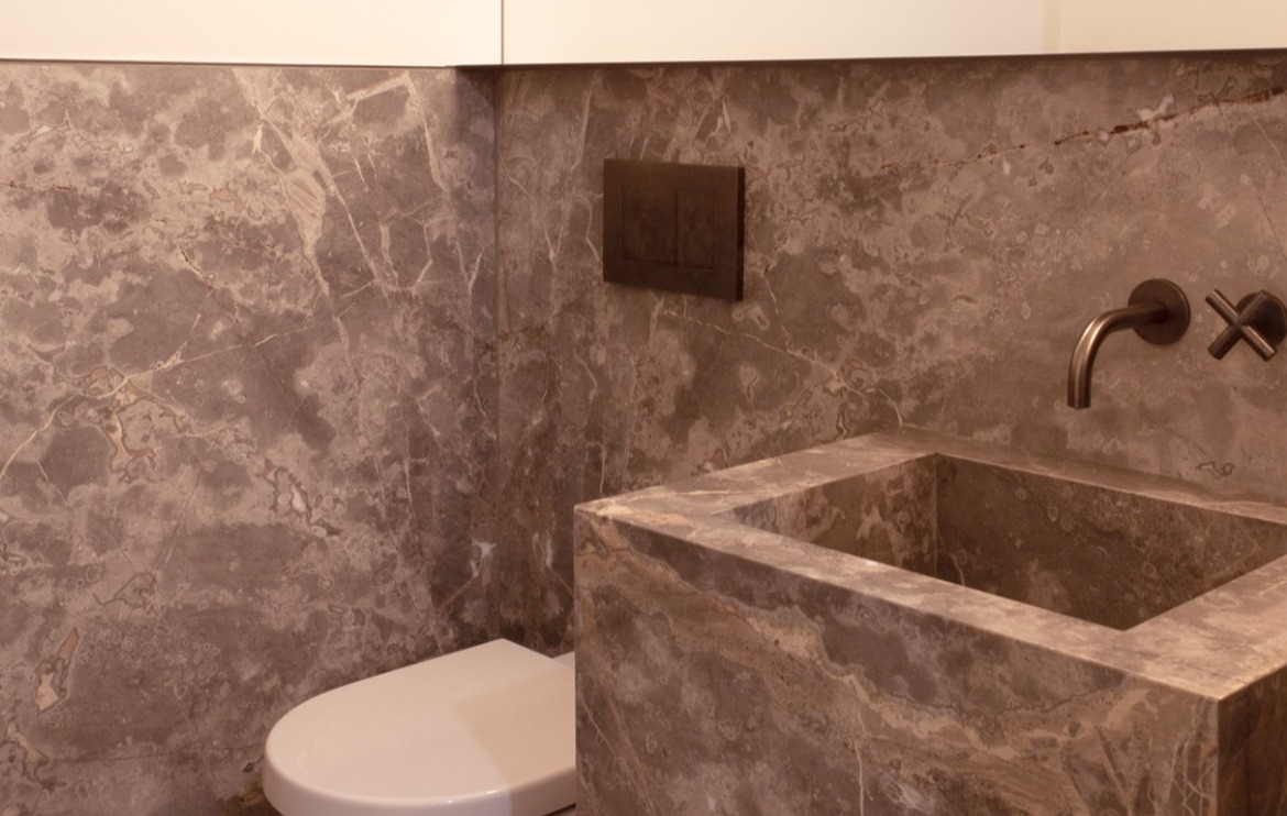 Powder room with stone detailing in Toronto addition and renovation