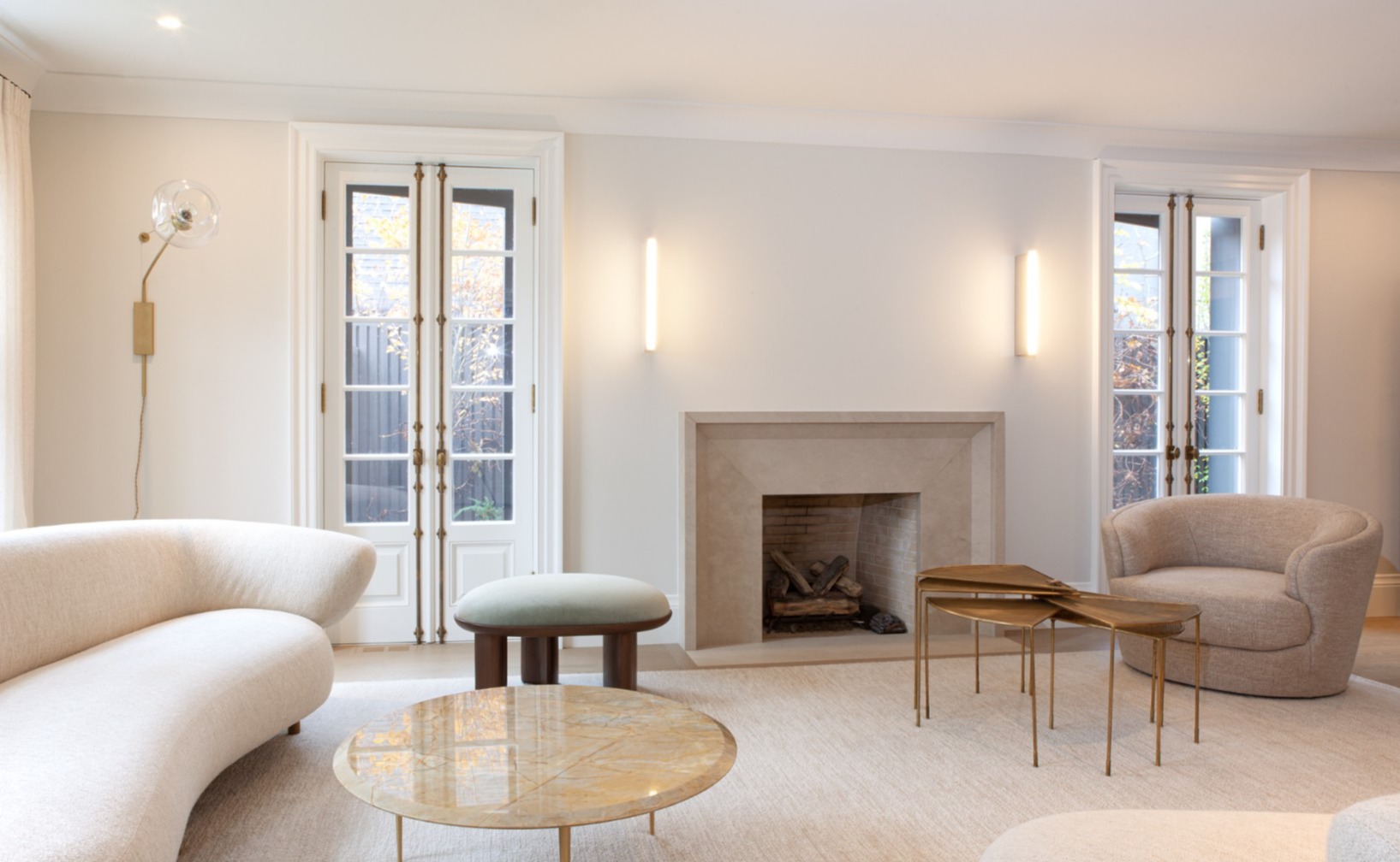 Two white French doors with stone fireplace in between in Toronto renovation and addition by SevernWoods-1