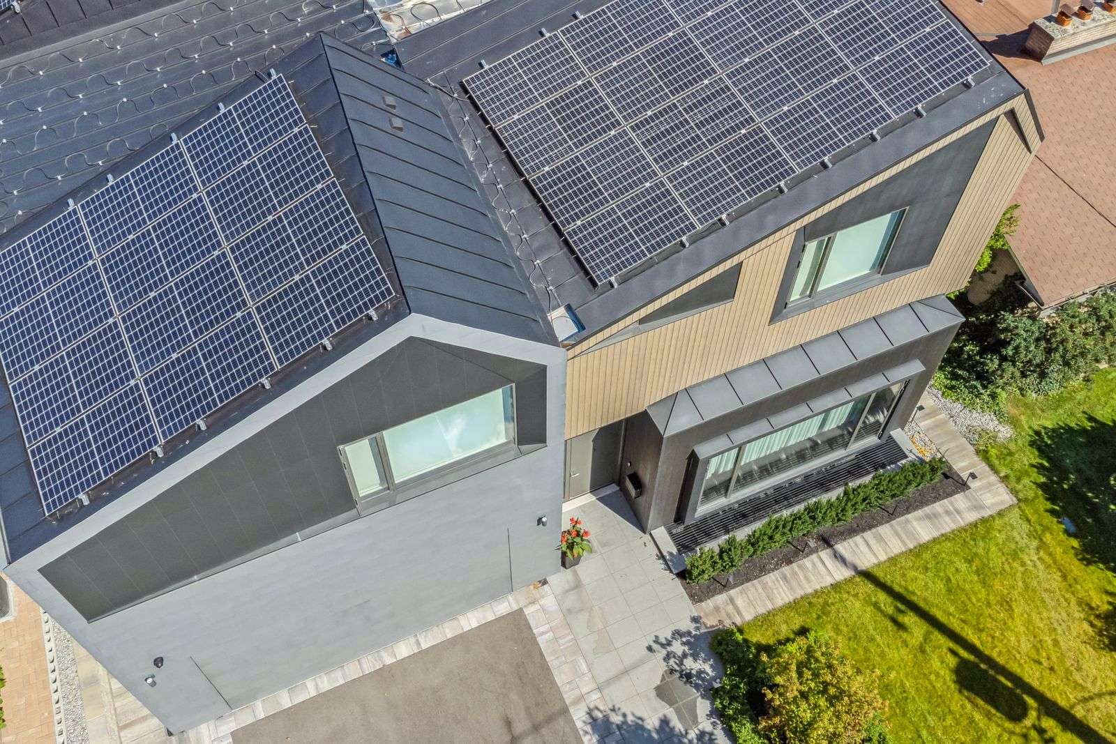 aerial rooftop modern zinc cladding with solar panels and skylight in home renovation in toronto12