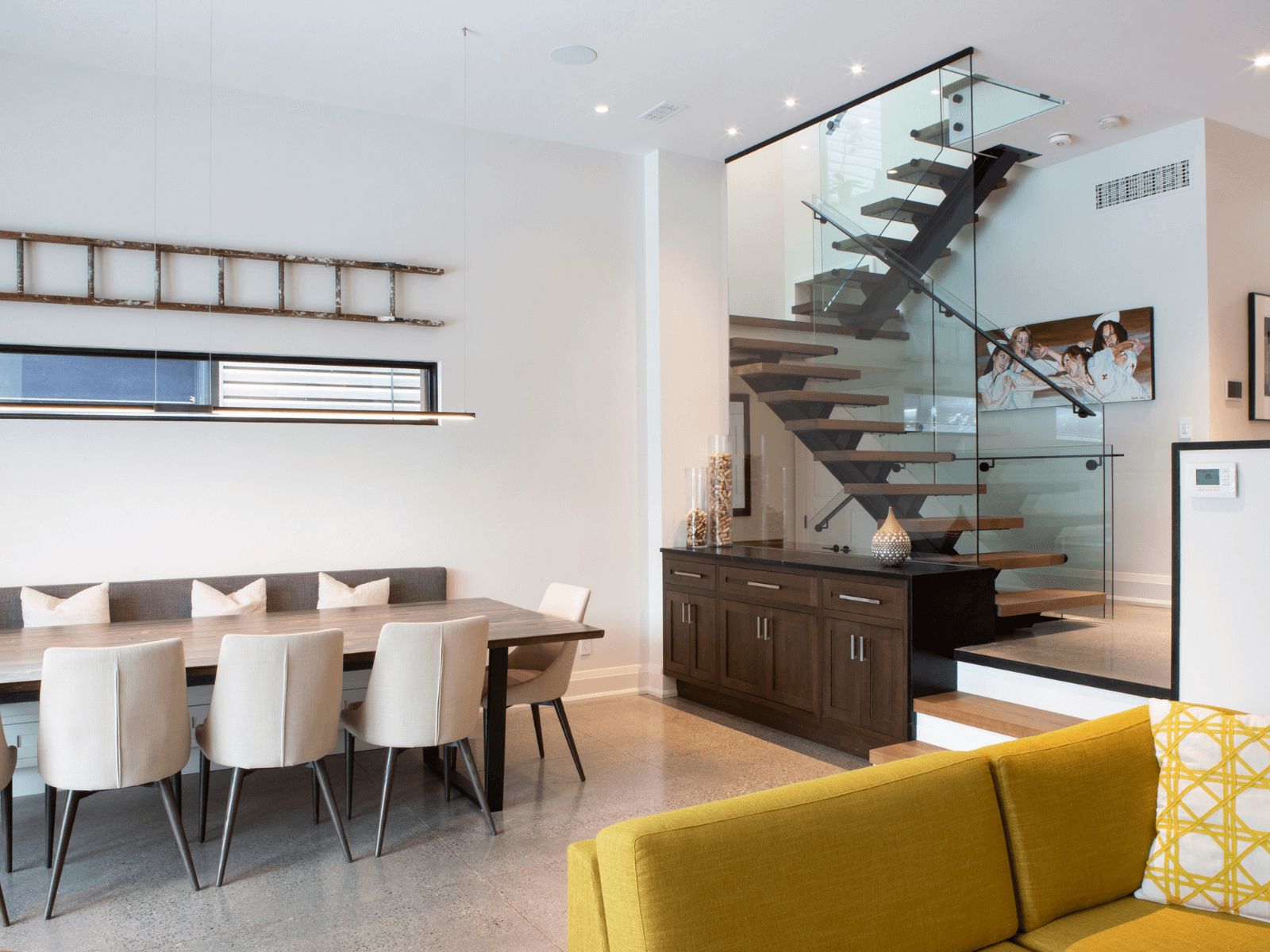 Leslieville Century Home Renovation with dining area and glass staircase