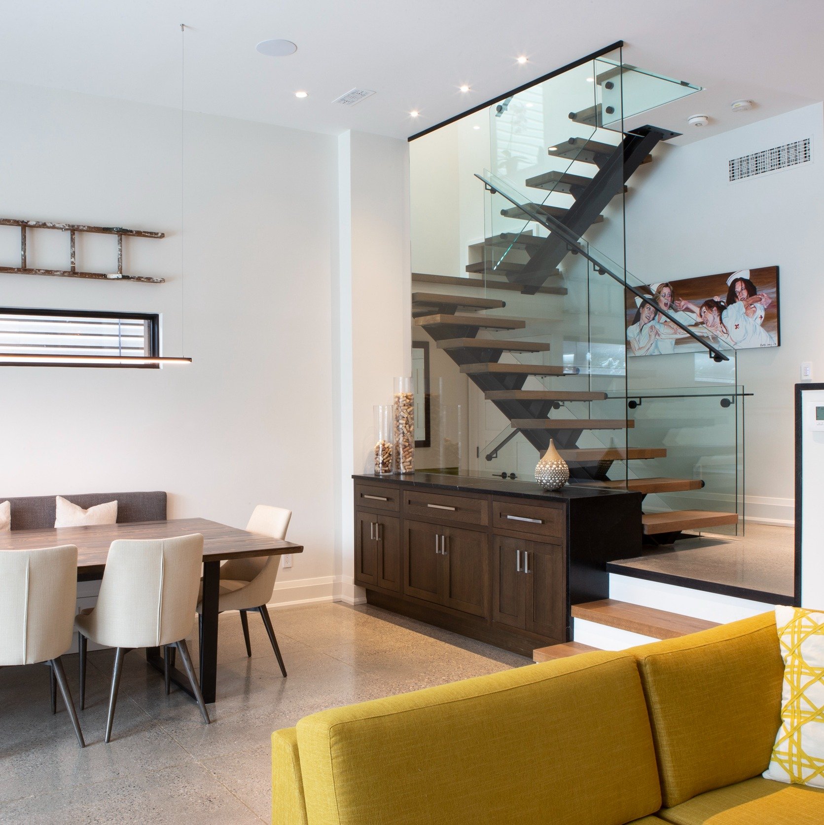 Contemporary home showcasing dining area and staircase