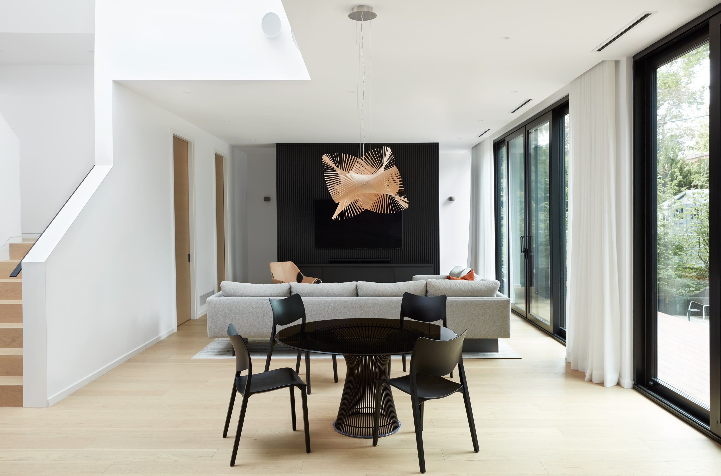 minimal modern living room with circular pendant lighting
