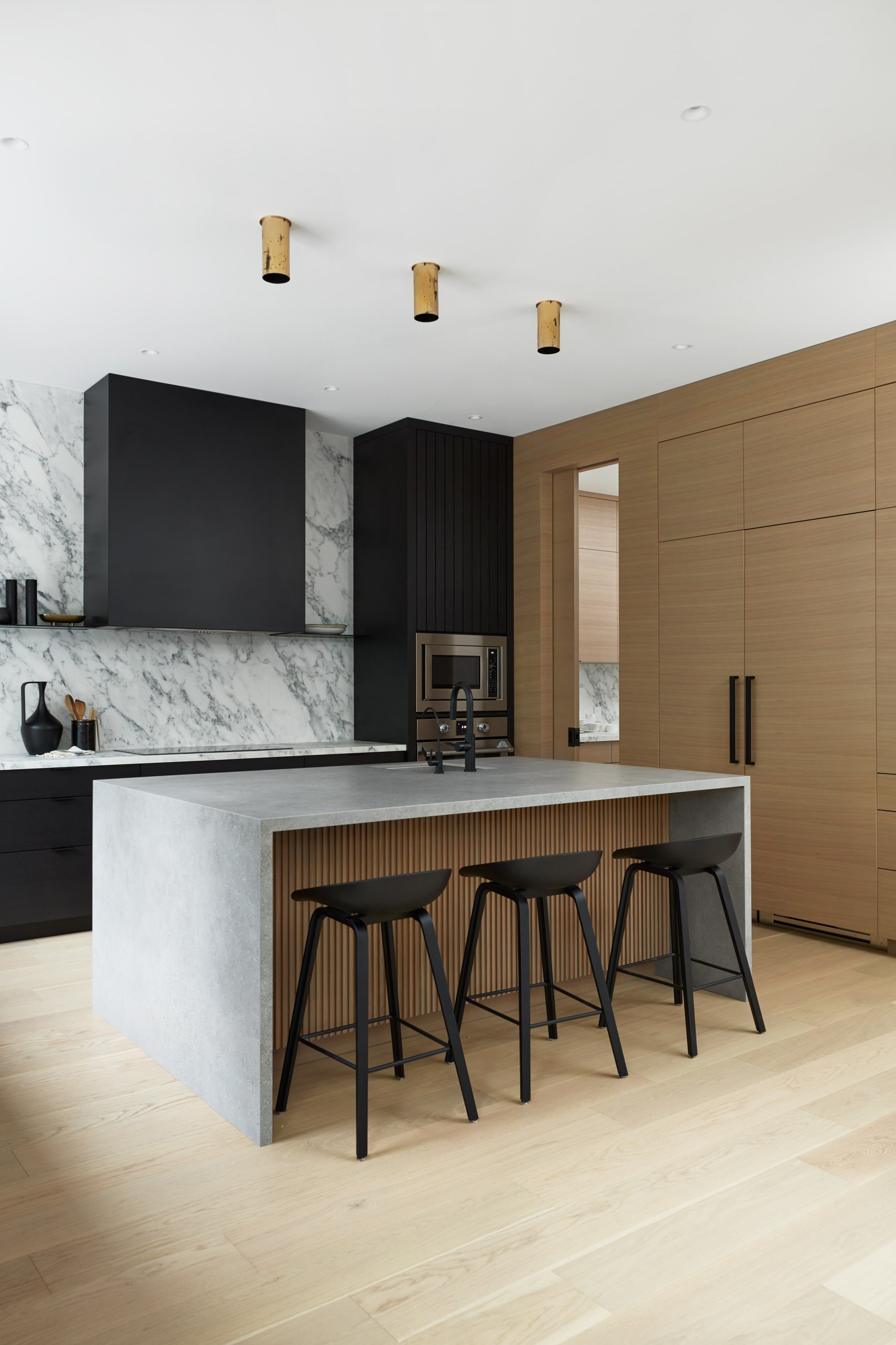 modern minimal kitchen with hidden sub zero fridge and neutral palettes with touches of black