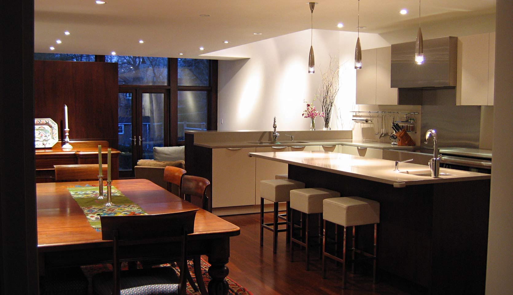 Modern kitchen with pendant lighting and white flat panel cabinetry 