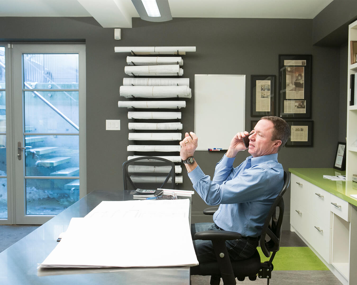 Founder of SevernWoods, Tom Cumming, at desk in office on the phone