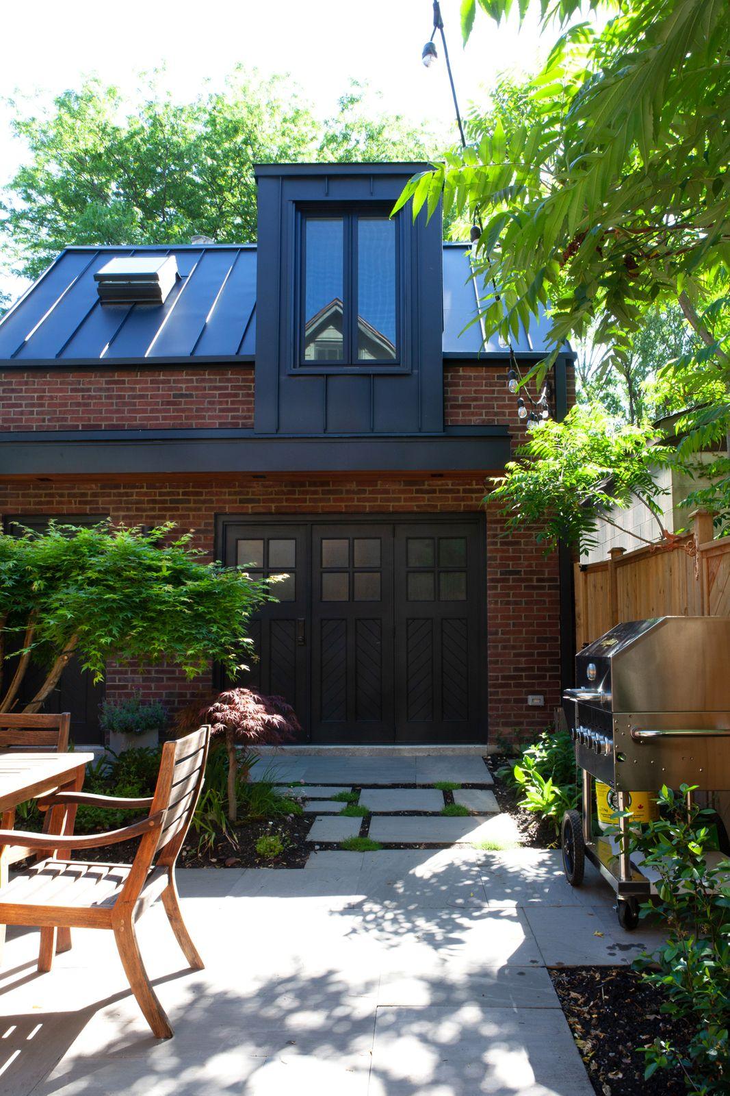 Backyard of brick laneway home with outdoor grill and seating area Backyard of brick laneway home with outdoor grill and seating area