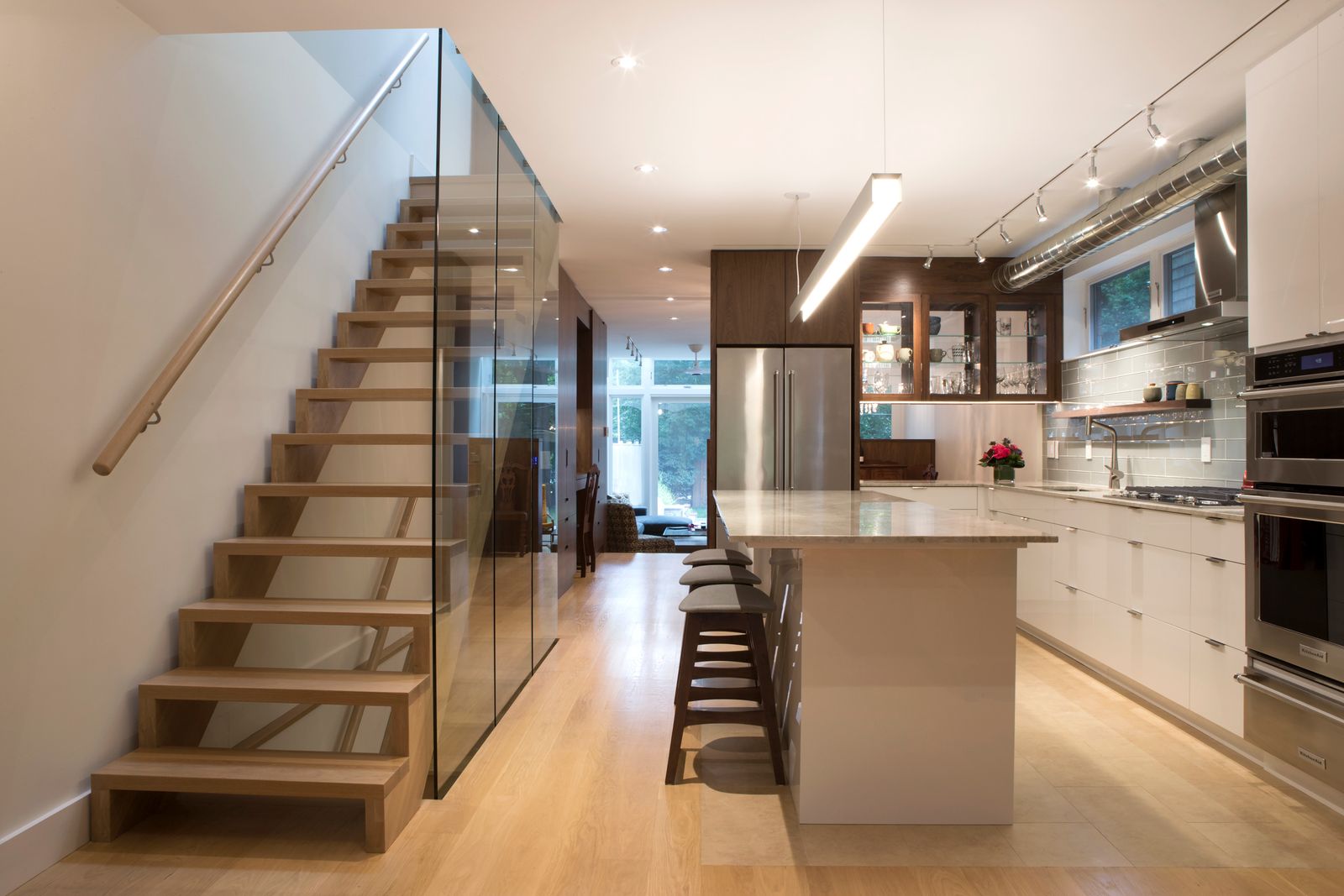 upper beach custom kitchen renovation in toronto with floating staircase and glass siding