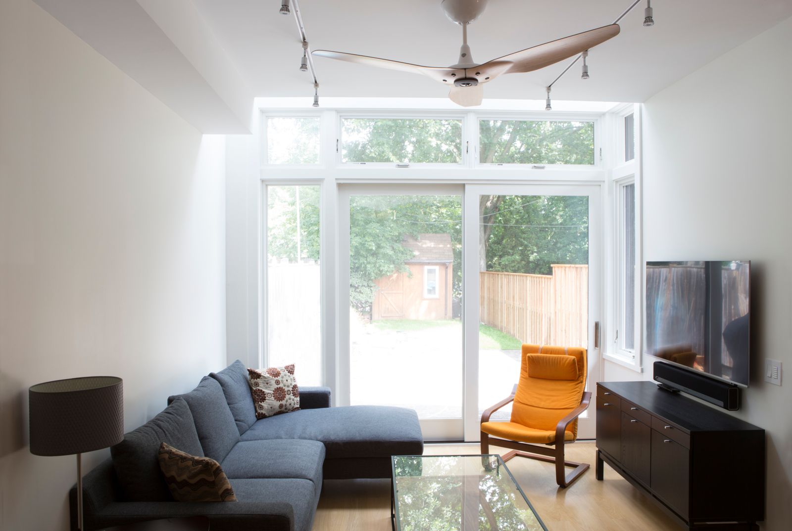 Luxury family room area with sliding glass doors to backyard