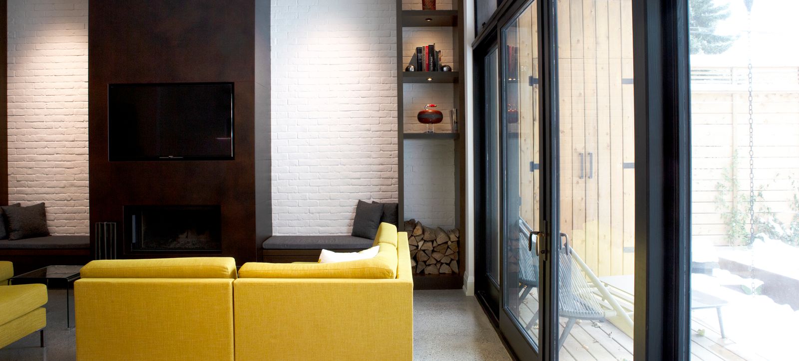 white brick living room toronto ontario with bright yellow couch